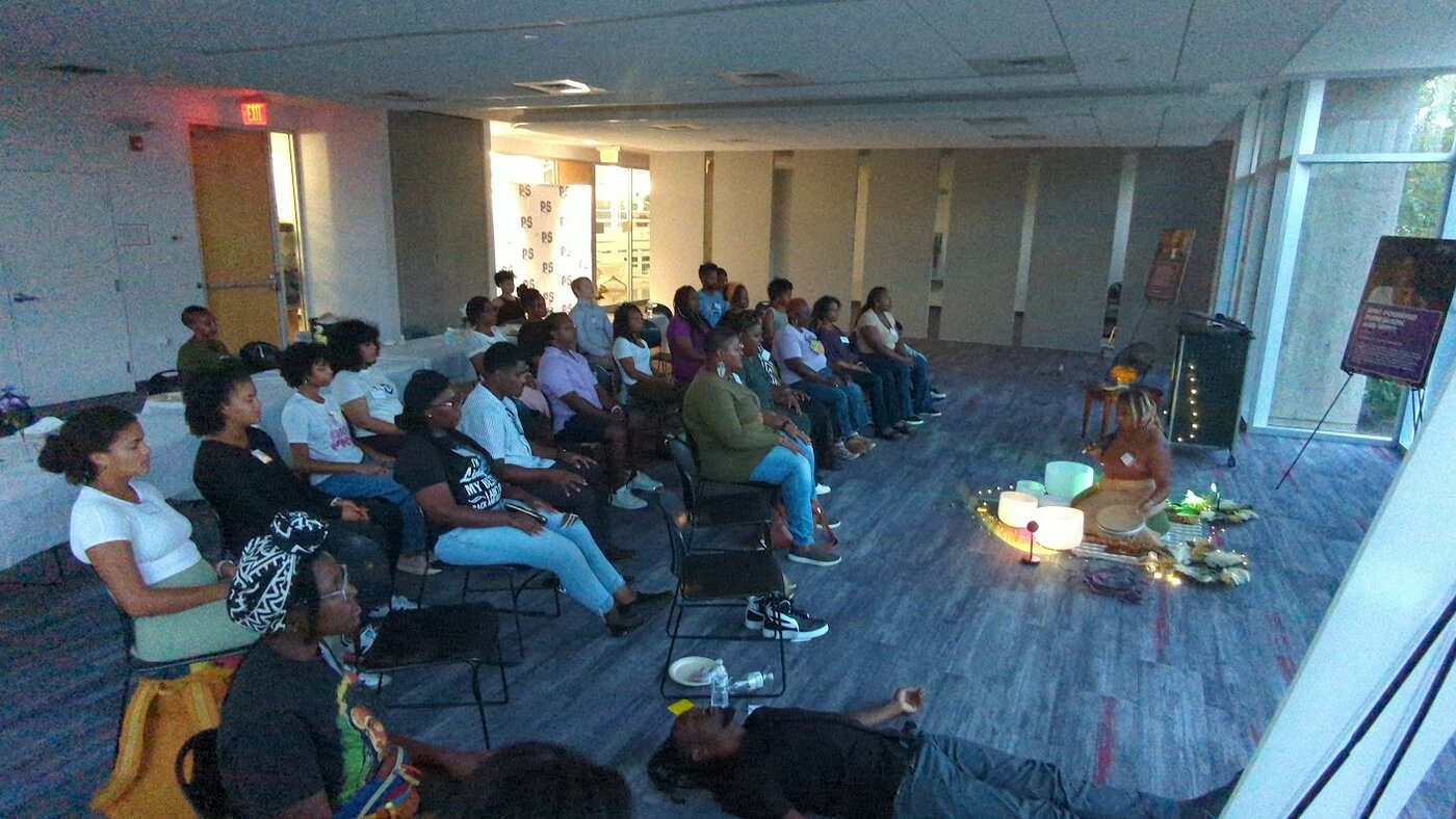 A room of people resting during a group sound healing session