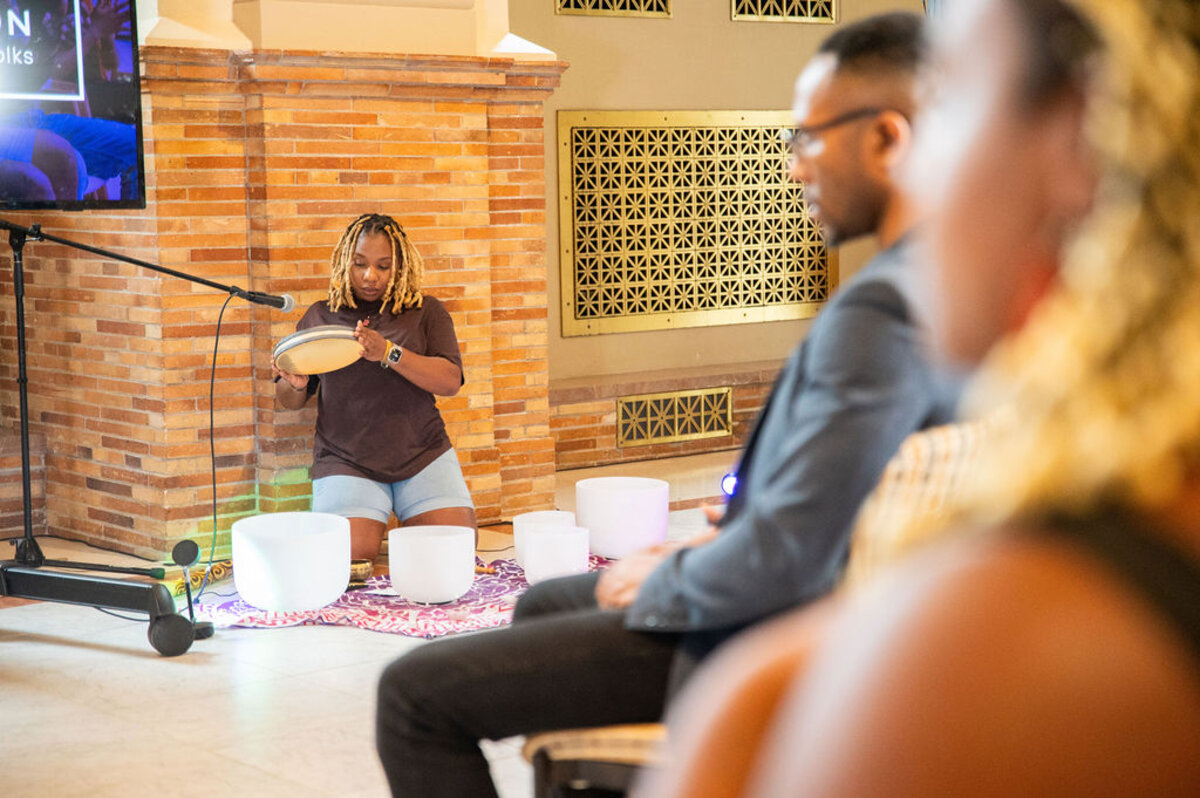 Jessica playing crystal singing bowls during a sound bath