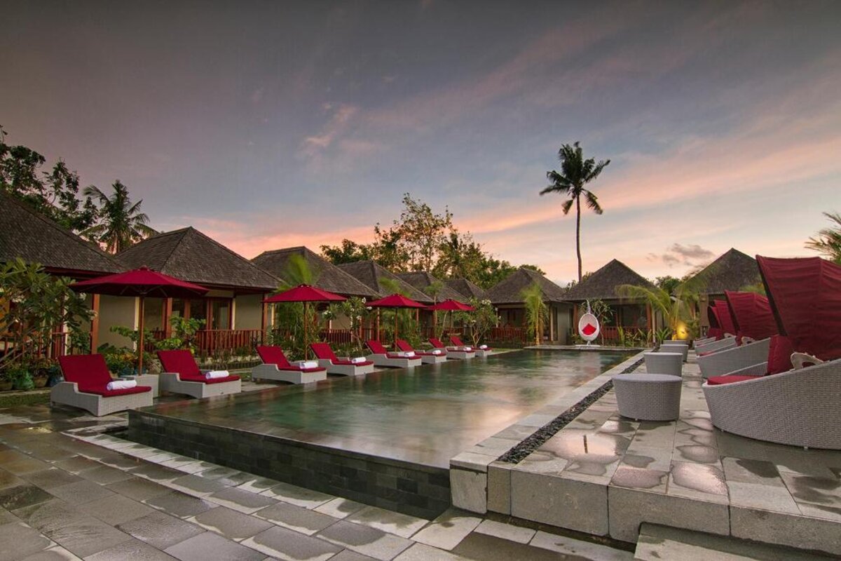 Poolside loungers surrounded by tropical gardens